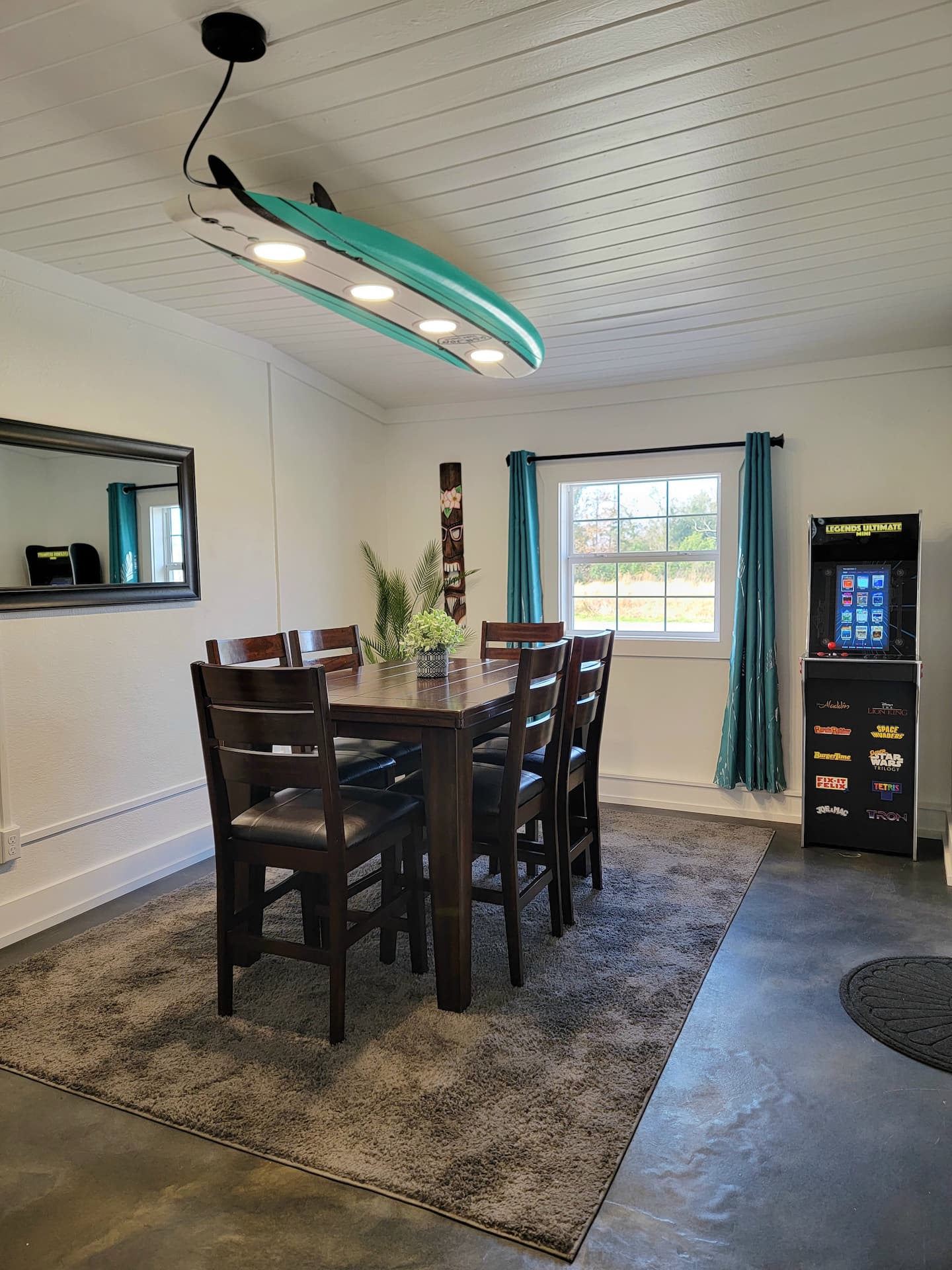 Bright Coastal Drift bedroom with a comfortable bed, ceiling fan, bedside lighting, and two windows.