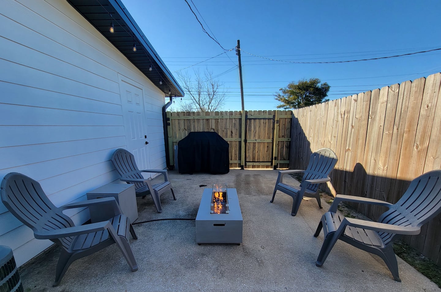 Fully equipped kitchen with stainless appliances, generous counters, and open shelving.