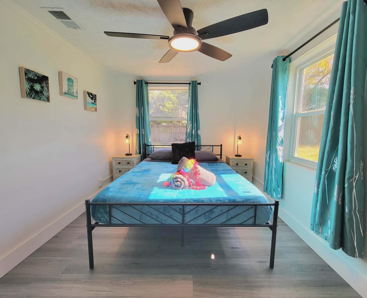 Spacious living room with sectional sofa, ceiling fan, and easy access to the bedrooms.